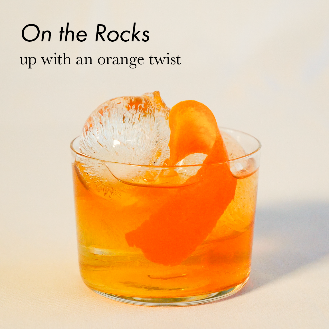 Manhattan on the rocks, up with an orange twist.