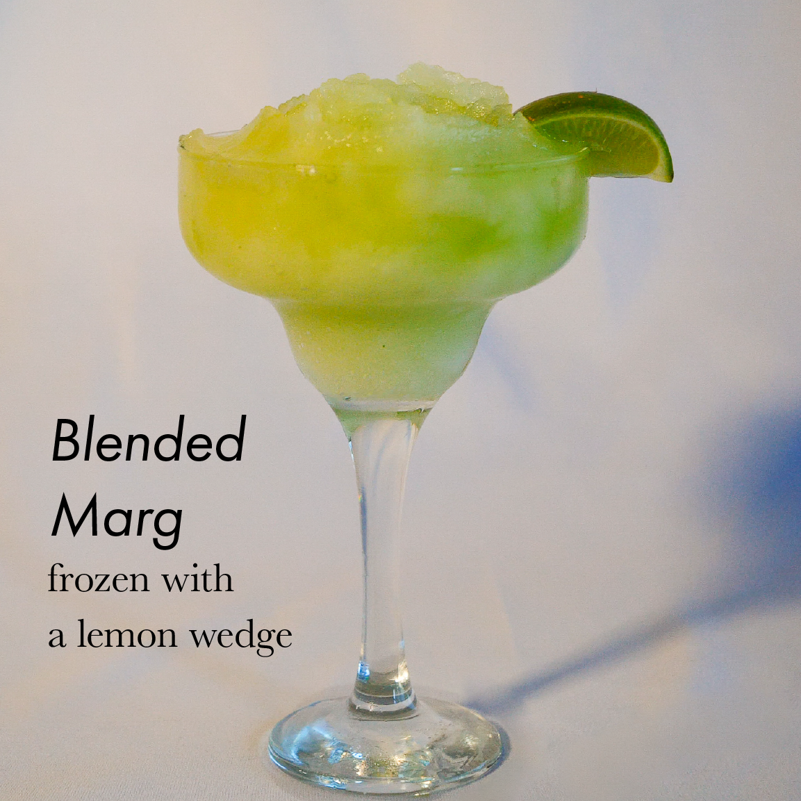 Blended Margarita frozen with a lemon wedge
